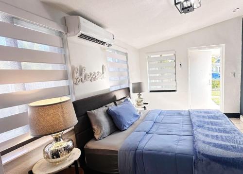 a bedroom with a bed with a blue blanket at Private studio by Miami International Airport in Miami