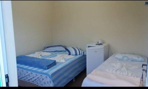 Ein Bett oder Betten in einem Zimmer der Unterkunft Hospedaria Coração de Pedra