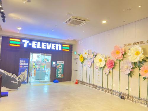 a store lobby with flowers on the wall at Jeju Central City Hotel in Jeju