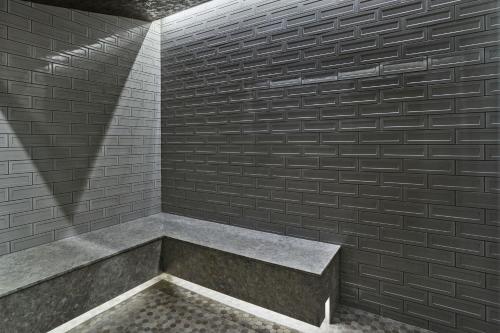 a bathroom with a brick wall and a bench at The Ritz-Carlton, Lake Tahoe in Truckee