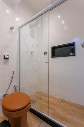 a bathroom with a shower with a toilet and a television at Apartamento Copacabana in Rio de Janeiro