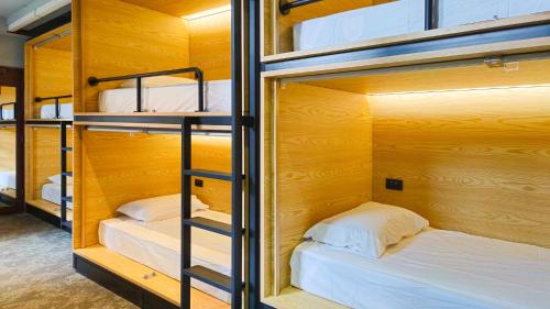 a group of bunk beds in a room at The Capsule Hotel in Sydney