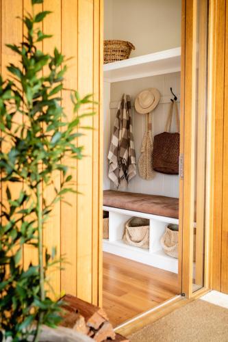 a closet with hats on shelves in a room at Upland Farm Luxury Cabins, Denmark Western Australia in Denmark