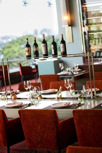 a table in a restaurant with bottles of wine at Marriott Executive Apartment - Lakeside Chalet, Mumbai in Mumbai