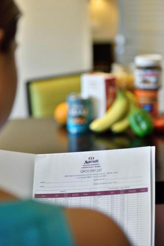 a table with a calender on a table with bananas at Marriott Executive Apartment - Lakeside Chalet, Mumbai in Mumbai