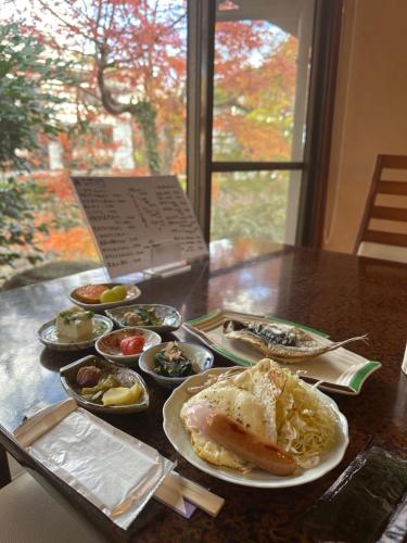 a table with plates of food on a table at Onsen Yado Mizuguchi in Izu