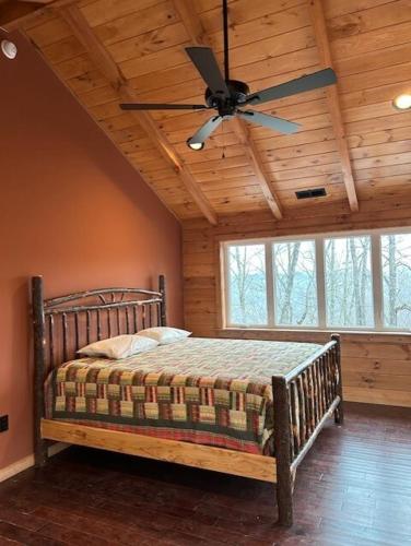 a bedroom with a bed with a ceiling fan at The Sky Breeze in Topton