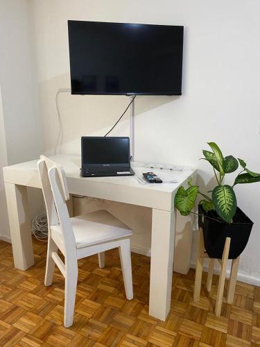 a white desk with a laptop computer on it at Palermo Botánico in Buenos Aires
