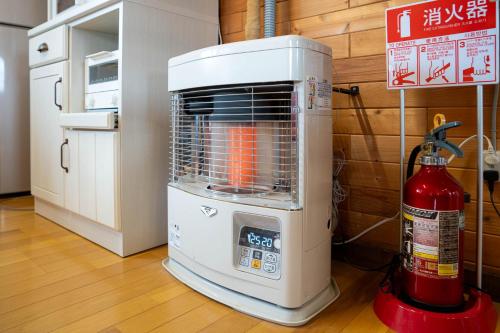 a air conditioner sitting on the floor next to a fire extinguisher at c-flat in Niki
