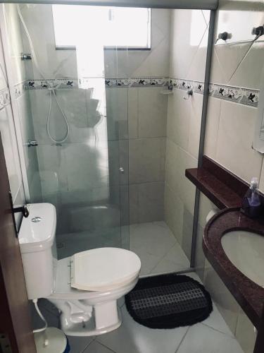a bathroom with a shower and a toilet and a sink at Cobertura Encantadora Conde PB in Conde