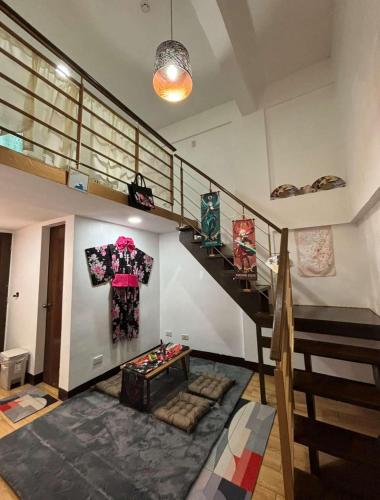 a living room with a staircase and a stair case at Apartment MJ in Olongapo