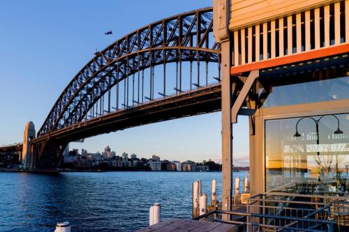a bridge over the water next to a building at Pier One Sydney Harbour, Autograph Collection in Sydney