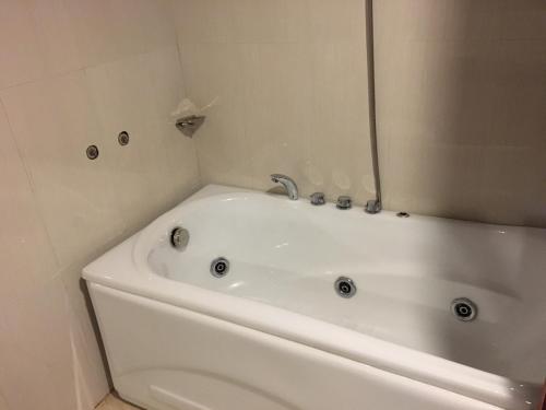 a white bath tub in a bathroom at Vinh Plaza Hotel in Vinh