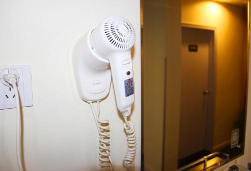 a hair dryer on a wall in a room at 7Days Inn Langfang Dachang North Rongchang Road in Dachang