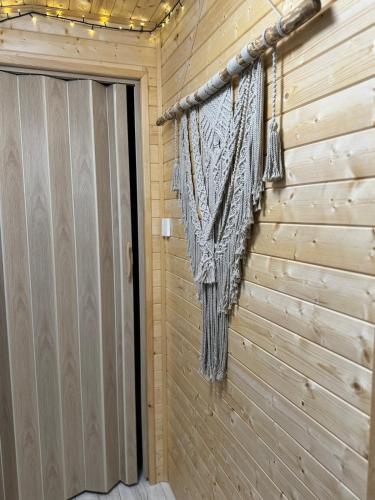 a room with a wooden wall with a door at Tiny House v Balijském stylu v srdci Slovácka in Uherský Ostroh