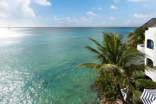 a view of the ocean next to a building at Coralita Apartments in Saint Michael