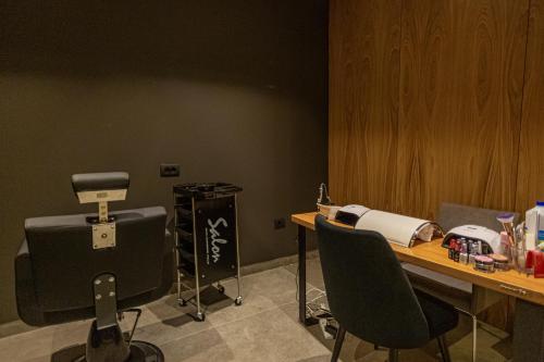 a room with a desk with a hair dryer and a machine at Andon Lapa Hotel & Spa in Sarandë