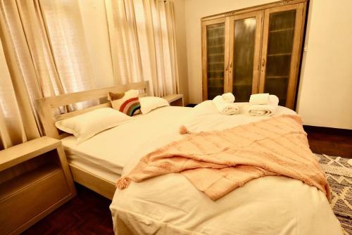 a bedroom with two beds with towels on them at Wanderer's Home Dhumbarahi in Kathmandu