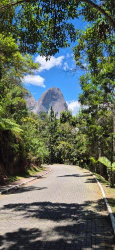 a winding road with a mountain in the background at Vista Azul Apart Hotel - Com Cozinha Compacta in Pedra Azul