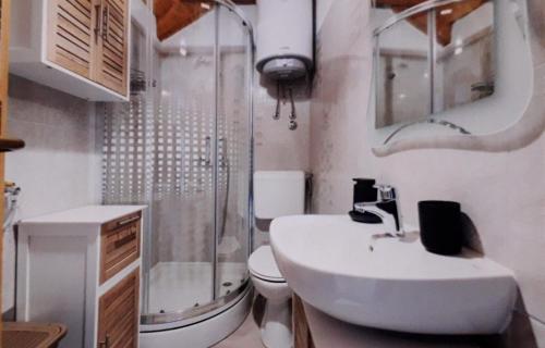 a bathroom with a sink and a shower and a toilet at Seaside holiday house Maslinica, Solta - 23838 in Grohote