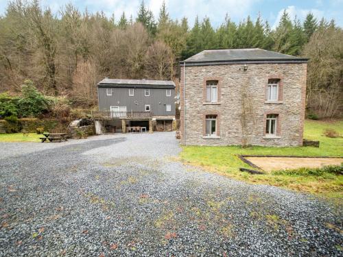 an old brick building sitting on the side of a road at Historic Watermill in Bohan in Vresse-sur-Semois