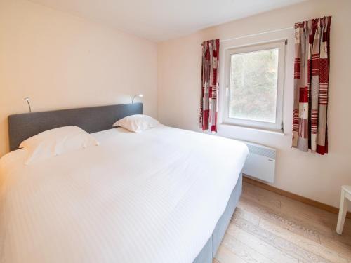 a white bed in a room with a window at Historic Watermill in Bohan in Vresse-sur-Semois