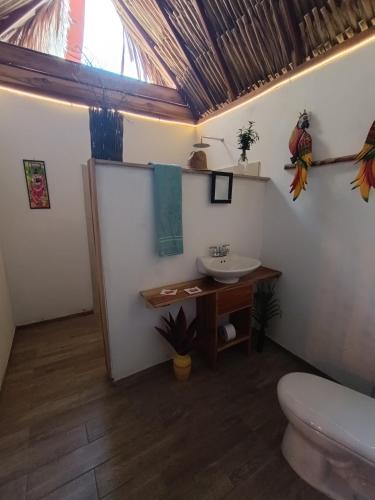 a bathroom with a sink and a toilet at El Paraiso de Carmen in Palomino