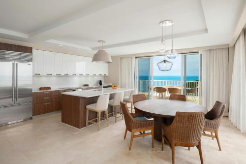 a kitchen and dining room with a table and chairs at The St. Regis Bermuda Resort in Saint George