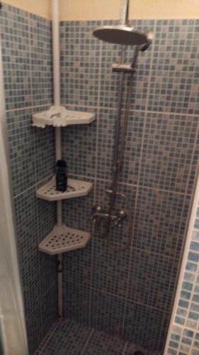 a shower with three white shelves in a bathroom at Villa Belle Horizon in La Trinité