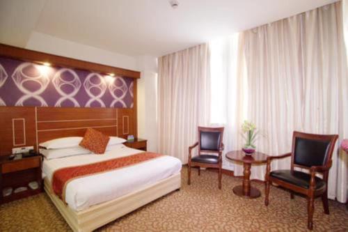 Tempat tidur dalam kamar di Shanghai YUHANG Hotel