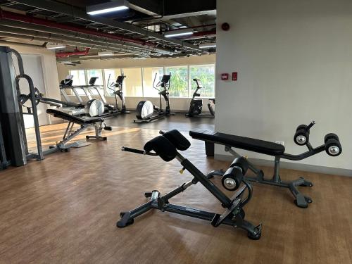 a gym with several exercise bikes in a room at Cozy Condo bedroom in Bacolod City in Bacolod