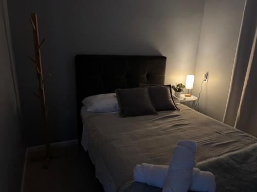 a bedroom with a large bed with two towels on it at B&B Pacuare River Gateway Tica House in Linda Vista