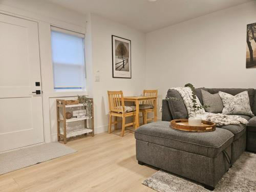 a living room with a couch and a table at Cozy new Suite in Silver Valley in Maple Ridge District Municipality