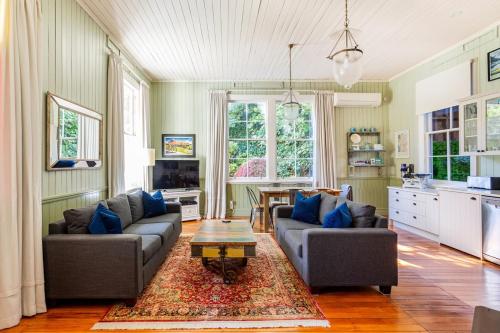 a living room with two couches and a table at Old School House in Queenstown