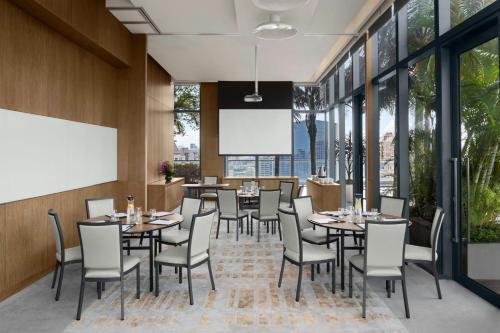 a restaurant with tables and chairs and windows at Courtyard by Marriott Singapore Novena in Singapore