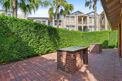 a brick bench on a brick walkway in front of a building at Elegant Stay in Balmain with Pool Access in Sydney