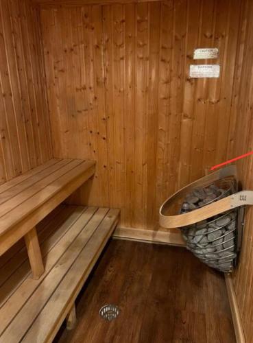 a sauna with a bench and a basket of rocks at Newly Renovated Villa with King Bed and Amenities, 1 mile to Mohegan Sun in Norwich