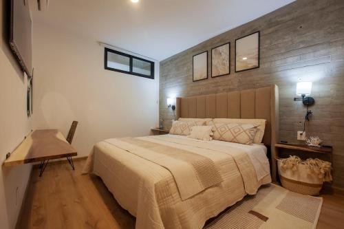 a bedroom with a large bed with a wooden headboard at MarinaWellmina-Sunset Pool Vibes in La Paz