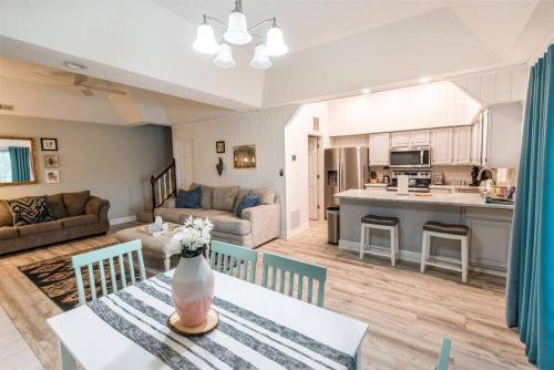 a living room with a dining table and a kitchen at Serene Duplex Lakefront Retreat: sleeps up to 20 in Rocky Mount