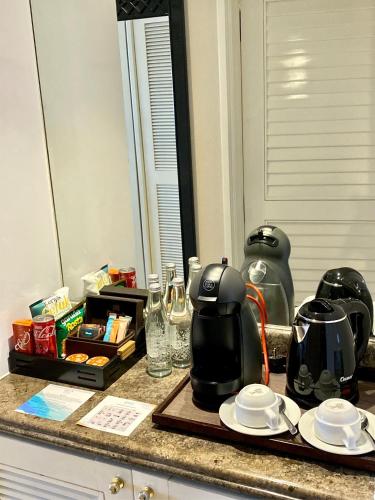 a kitchen counter with a coffee maker on a tray at Melia Purosani Yogyakarta in Yogyakarta