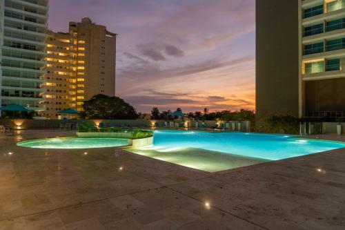 a large swimming pool in a city at night at Apto de Lujo con Vista al Mar en Playa Bello Horizonte in Santa Marta