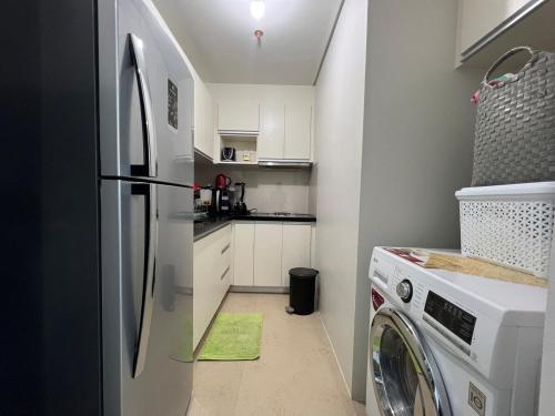 a kitchen with a refrigerator and a washer and dryer at Oceanview Condo in Boracay in Boracay