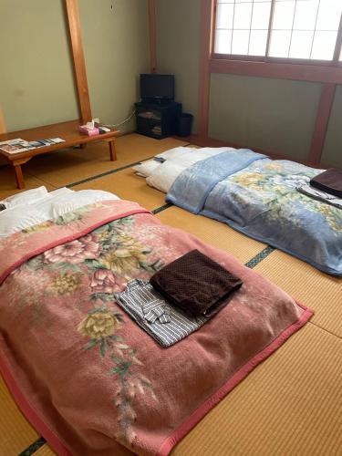 Postel nebo postele na pokoji v ubytování 民宿上田屋