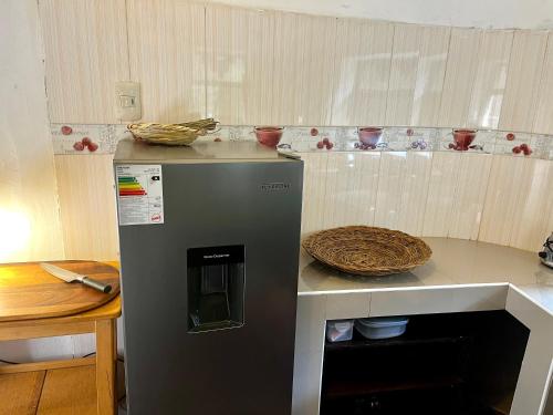 a kitchen with a counter top with a refrigerator at Casita Río Floresta Pisac in Pisac