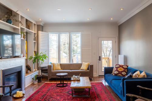 a living room with a couch and a fireplace at Beautiful 3BR House in the Heart of Greek Town in Toronto