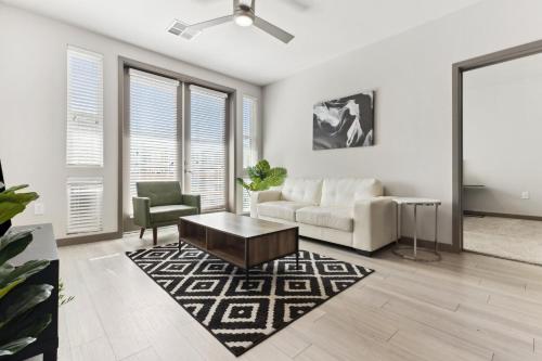 a living room with a couch and a chair at Cozysuites PHX RORO Gym Pool Pets Parking #18 in Phoenix