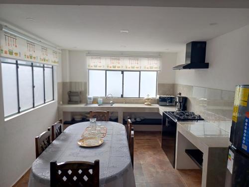 a kitchen with a table with chairs and a sink at El Renacimiento - Suite Cardinal in Cuenca
