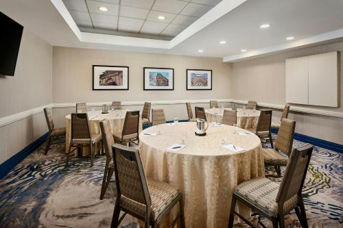 a conference room with tables and chairs and a podium at Sheraton Hamilton Hotel in Hamilton