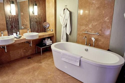 a bathroom with two sinks and a bath tub at Sheraton Lima Historic Center in Lima