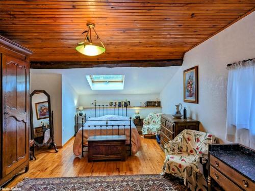 a bedroom with a bed and a wooden ceiling at Grande Maison Familiale Rénovée à Froideterre - FR-1-583-374 in Froideterre